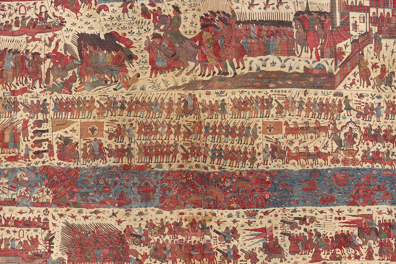 A woven fabric of a battle seen from above with rivers and dozens of crudely-rendered soldiers